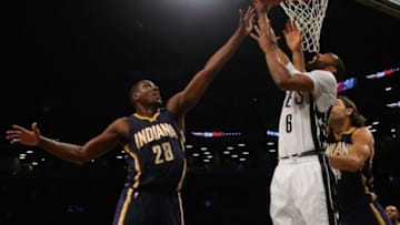 Mar 31, 2015; Brooklyn, NY, USA; Brooklyn Nets guard Alan Anderson (6) shoots against Indiana Pacers center Ian Mahinmi (28) and forward Luis Scola (4) during the first half at Barclays Center. Mandatory Credit: Adam Hunger-USA TODAY Sports