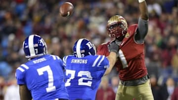 Dec 7, 2013; Charlotte, NC, USA; Duke Blue Devils quarterback Anthony Boone (7) passes the ball as offensive tackle Perry Simmons (72) blocks and Florida State Seminoles linebacker Christian Jones (7) pressures in the third quarter at Bank of America Stadium. Mandatory Credit: Bob Donnan-USA TODAY Sports