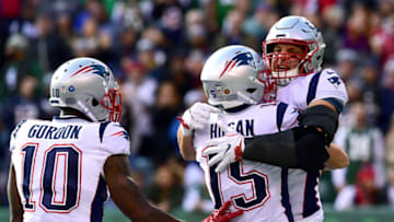 EAST RUTHERFORD, NEW JERSEY - NOVEMBER 25: Rob Gronkowski #87 of the New England Patriots is congratulated by his teammates Chris Hogan #15 and Josh Gordon #10 after his first quarter touchdown reception against the New York Jets at MetLife Stadium on November 25, 2018 in East Rutherford, New Jersey. (Photo by Sarah Stier/Getty Images)