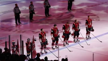 GLENDALE, ARIZONA - DECEMBER 19: The Arizona Coyotes stand for the national anthem before the NHL game against the Minnesota Wild at Gila River Arena on December 19, 2019 in Glendale, Arizona. (Photo by Christian Petersen/Getty Images)