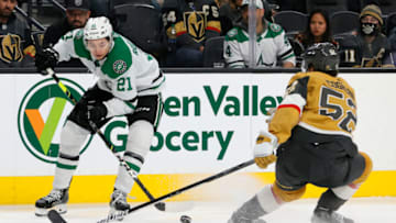 LAS VEGAS, NEVADA - DECEMBER 08: Jason Robertson #21 of the Dallas Stars controls the puck against Dylan Coghlan #52 of the Vegas Golden Knights in the third period of their game at T-Mobile Arena on December 8, 2021 in Las Vegas, Nevada. The Golden Knights defeated the Stars 5-4. (Photo by Ethan Miller/Getty Images)