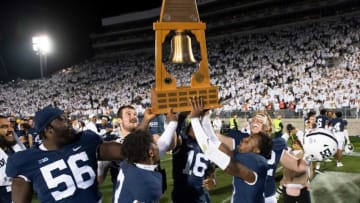 Penn State players laugh as they pretend to drop the Governor's Victory Bell trophy after defeating Minnesota, 45-17, in a White Out game at Beaver Stadium on Saturday, Oct. 22, 2022, in State College.Hes Dr 102222 Whiteout