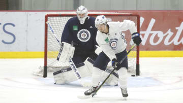 Winnipeg Jets, Mark Scheifele (55), Connor Hellebuyck (37). Mandatory Credit: James Carey Lauder-USA TODAY Sports
