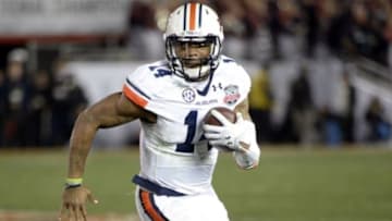 Jan 6, 2014; Pasadena, CA, USA; Auburn Tigers quarterback Nick Marshall (14) runs against the Florida State Seminoles during the second half of the 2014 BCS National Championship game at the Rose Bowl. Mandatory Credit: Richard Mackson-USA TODAY Sports
