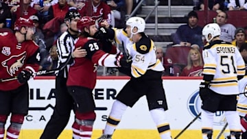 Nov 12, 2016; Glendale, AZ, USA; Boston Bruins defenseman Adam McQuaid (54) punches Arizona Coyotes center Ryan White (25) during the first period at Gila River Arena. Mandatory Credit: Matt Kartozian-USA TODAY Sports