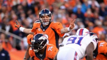 Dec 7, 2014; Denver, CO, USA; Denver Broncos quarterback Peyton Manning (18) calls an audible in the third quarter against the Buffalo Bills at Sports Authority Field at Mile High. The Broncos defeated the Bills 24-17. Mandatory Credit: Ron Chenoy-USA TODAY Sports