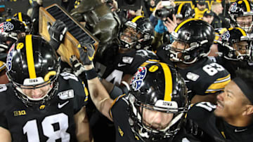 IOWA CITY, IOWA- NOVEMBER 16: Offensive lineman Tristan Wirfs #74 of the Iowa Hawkeyes lifts the Floyd of Rosedale trophy after the 23-19 win over the Minnesota Gophers on November 16, 2019 at Kinnick Stadium in Iowa City, Iowa. (Photo by Matthew Holst/Getty Images)