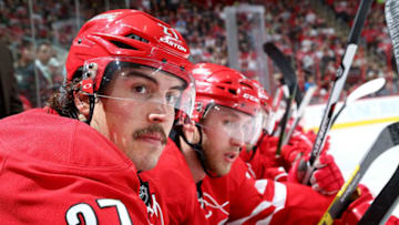 RALEIGH, NC - DECEMBER 21: Justin Faulk #27 of the Carolina Hurricanes and teammate Jaccob Slavin #74 watch action on the ice from the bench area during a NHL game against the Washington Capitals at PNC Arena on December 21, 2015 in Raleigh, North Carolina. (Photo by Gregg Forwerck/NHLI via Getty Images)