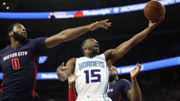 Apr 12, 2015; Auburn Hills, MI, USA; Charlotte Hornets guard Kemba Walker (15) shoots the ball as Detroit Pistons center Andre Drummond (0) and forward Greg Monroe (10) defend during the first quarter at The Palace of Auburn Hills. Mandatory Credit: Raj Mehta-USA TODAY Sports