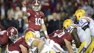 Nov 9, 2013; Tuscaloosa, AL, USA; Alabama Crimson Tide quarterback AJ McCarron (10) signals at the line of scrimmage against the LSU Tigers during the third quarter at Bryant-Denny Stadium. Mandatory Credit: John David Mercer-USA TODAY Sports