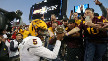 TUCSON, AZ - NOVEMBER 24: Quarterback Manny Wilkins #5 of the Arizona State Sun Devils holds the Territorial Cup as he celebrates with fans following a 41-40 victory against the Arizona Wildcats during the college football game at Arizona Stadium on November 24, 2018 in Tucson, Arizona. (Photo by Ralph Freso/Getty Images)