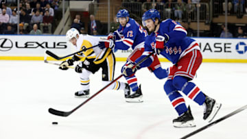 Apr 7, 2022; New York, New York, USA; New York Rangers defenseman Jacob Trouba (8) brings the puck up ice against the Pittsburgh Penguins during the second period at Madison Square Garden. Mandatory Credit: Brad Penner-USA TODAY Sports