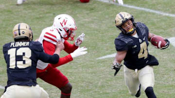 Purdue wide receiver Rondale Moore (4) runs the ball as Purdue quarterback Jack Plummer (13) blocks Nebraska safety Marquel Dismuke (9) during the first quarter of an NCAA college football game, Saturday, Dec. 5, 2020 at Ross-Ade Stadium in West Lafayette.Cfb Purdue Vs Nebraska