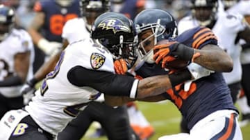 Nov 17, 2013; Chicago, IL, USA; Chicago Bears wide receiver Brandon Marshall (15) is tackled by Baltimore Ravens cornerback Jimmy Smith (22)during the first quarter at Soldier Field. Mandatory Credit: Rob Grabowski-USA TODAY Sports