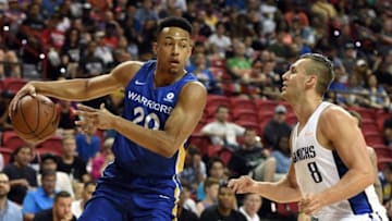 LAS VEGAS, NV - JULY 09: Elijah Brown #20 of the Golden State Warriors passes against Kyle Collinsworth #8 of the Dallas Mavericks during the 2018 NBA Summer League at the Thomas & Mack Center on July 9, 2018 in Las Vegas, Nevada. The Mavericks defeated the Warriors 91-71. NOTE TO USER: User expressly acknowledges and agrees that, by downloading and or using this photograph, User is consenting to the terms and conditions of the Getty Images License Agreement. (Photo by Ethan Miller/Getty Images)
