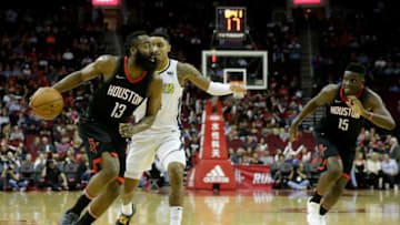 HOUSTON, TX - FEBRUARY 09: James Harden #13 of the Houston Rockets drives to the basket defended by Gary Harris #14 of the Denver Nuggets in the first half at Toyota Center on February 9, 2018 in Houston, Texas. NOTE TO USER: User expressly acknowledges and agrees that, by downloading and or using this Photograph, user is consenting to the terms and conditions of the Getty Images License Agreement. (Photo by Tim Warner/Getty Images)
