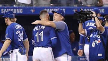 TORONTO, ON - SEPTEMBER 7: Kevin Pillar #11 of the Toronto Blue Jays is congratulated by manager John Gibbons #5 after hitting a game-winning solo home run in the eleventh inning during MLB game action against the Cleveland Indians at Rogers Centre on September 7, 2018 in Toronto, Canada. (Photo by Tom Szczerbowski/Getty Images)