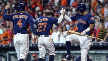 Jul 24, 2016; Houston, TX, USA; Houston Astros second baseman Jose Altuve (27) celebrates with designated hitter George Springer (4) and shortstop Carlos Correa (1) after hitting a home run during the second inning against the Los Angeles Angels at Minute Maid Park. Mandatory Credit: Troy Taormina-USA TODAY Sports