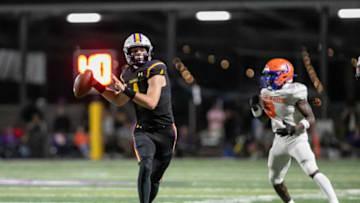 Calvary’s quarterback Jake Merklinger breaks outside the pocket to complete a touchdown pass down field.