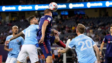 Aug 4, 2021; Chicago, Illinois, USA; Chicago Fire defender Boris Sekulic (2) heads the ball against New York City midfielder Valentin Castellanos (11) during the second half at Soldier Field. Mandatory Credit: Mike Dinovo-USA TODAY Sports