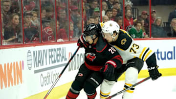 RALEIGH, NC - MAY 16: Sebastian Aho #20 of the Carolina Hurricanes looks to gain control of a puck along the boards at Charlie McAvoy #73 of the Boston Bruins defends in Game Four of the Eastern Conference Third Round during the 2019 NHL Stanley Cup Playoffs on May 16, 2019 at PNC Arena in Raleigh, North Carolina. (Photo by Gregg Forwerck/NHLI via Getty Images)
