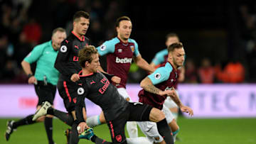 LONDON, ENGLAND - DECEMBER 13: Marko Arnautovic of West Ham United is tackled by Nacho Monreal of Arsenal during the Premier League match between West Ham United and Arsenal at London Stadium on December 13, 2017 in London, England. (Photo by Shaun Botterill/Getty Images)