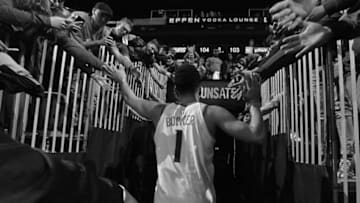 PHOENIX, AZ - JANUARY 2:(EDITORS NOTE: Image has been converted to black and white.) Devin Booker #1 of the Phoenix Suns walks off the court through the tunnel after the game against the Atlanta Hawks on January 2, 2018 at Talking Stick Resort Arena in Phoenix, Arizona. NOTE TO USER: User expressly acknowledges and agrees that, by downloading and or using this photograph, user is consenting to the terms and conditions of the Getty Images License Agreement. Mandatory Copyright Notice: Copyright 2018 NBAE (Photo by Barry Gossage/NBAE via Getty Images)