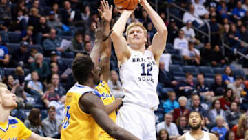 Dec 22, 2016; Provo, UT, USA; Brigham Young Cougars forward Eric Mika (12) shoots the ball over two Cal State Bakersfield Roadrunners players during the second half at Marriott Center. Brigham Young Cougars won the game 81-71. Mandatory Credit: Chris Nicoll-USA TODAY Sports
