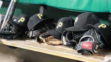 Jul 6, 2018; Pittsburgh, PA, USA; Pittsburgh Pirates hats and gloves in the dugout against the Philadelphia Phillies during the seventh inning at PNC Park. The Phillies won 17-5. Mandatory Credit: Charles LeClaire-USA TODAY Sports