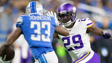DETROIT, MI - OCTOBER 20: Kerryon Johnson #33 of the Detroit Lions runes for a short gain as Xavier Rhodes #29 of the Minnesota Vikings gets ready to make the top during the first quarter of the game at Ford Field on October 20, 2019 in Detroit, Michigan. (Photo by Leon Halip/Getty Images)
