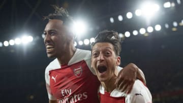 LONDON, ENGLAND - OCTOBER 22: Pierre-Emerick Aubamayang of Arsenal celebrates with Mesut Ozil after scoring Arsenal's third goal during the Premier League match between Arsenal FC and Leicester City at the Emirates Stadium on October 22, 2018 in London, United Kingdom. (Photo by Visionhaus/Getty Images)
