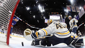 UNIONDALE, NEW YORK - MARCH 30: Anthony Beauvillier #18 of the New York Islanders scores at 6:07 of the third period against Carter Hutton #40 of the Buffalo Sabres at NYCB Live's Nassau Coliseum on March 30, 2019 in Uniondale, New York. The Islanders defeated the Sabres 5-1 to qualify for the playoffs. (Photo by Bruce Bennett/Getty Images)