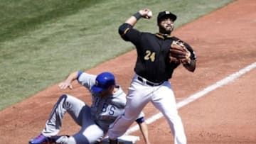Mar 31, 2014; Pittsburgh, PA, USA; Pittsburgh Pirates third baseman Pedro Alvarez (24) throws to first base to complete a double play after forcing out Chicago Cubs right fielder Nate Schierholtz (19) at third base in the fifth of an opening day baseball game at PNC Park. The Pirates won 1-0 in ten innings. Mandatory Credit: Charles LeClaire-USA TODAY Sports