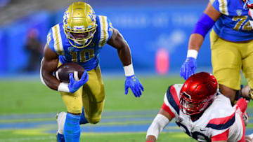 PASADENA, CA - NOVEMBER 28: Running back Demetric Felton #10 of the UCLA Bruins carries the ball for a gain in the game against the Arizona Wildcats at the Rose Bowl on November 28, 2020 in Pasadena, California. (Photo by Jayne Kamin-Oncea/Getty Images)