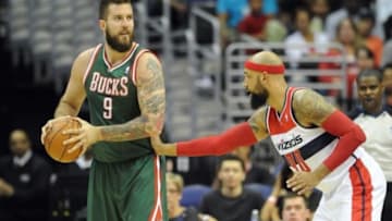 Apr 12, 2014; Washington, DC, USA; Milwaukee Bucks center Miroslav Raduljica (9) possesses the ball as Washington Wizards power forward Drew Gooden (90) defends during the first half at Verizon Center. Mandatory Credit: Brad Mills-USA TODAY Sports