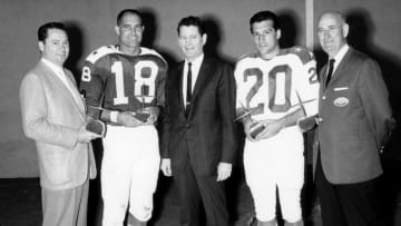 AFL Commissioner Joe Foss (center) awards Barron Hilton, president of the San Diego Chargers, Tobin Rote of the Chargers as Western Division Player of the Year, Gino Cappelletti of the Boston Patriots as the Eastern Division Player of the Year, and Billy Sullivan, President of the Boston Patriots. (Photo by Charles Aqua Viva/Getty Images)