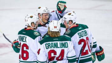 Feb 17, 2016; Calgary, Alberta, CAN; Minnesota Wild defenseman Ryan Suter (20) celebrates his goal with teammates against the Calgary Flames during the second period at Scotiabank Saddledome. Sergei Belski-USA TODAY Sports