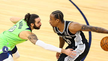 Ricky Rubio of the Minnesota Timberwolves guards DeMar DeRozan of the San Antonio Spurs. (Photo by Harrison Barden/Getty Images)