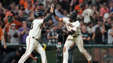 SAN FRANCISCO, CALIFORNIA - SEPTEMBER 25: Jaylin Davis #49 of the San Francisco Giants is congratulated by third base coach Ron Wotus #23 after Davis hit a walk-off solo home run to defeat the Colorado Rockies 2-1 in the bottom of the ninth inning at Oracle Park on September 25, 2019 in San Francisco, California. The home run was the first of Davis's career. (Photo by Thearon W. Henderson/Getty Images)