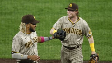 DENVER, CO - AUGUST 31: Fernando Tatis Jr. #23 of the San Diego Padres is congratulated by Jake Cronenworth #9 as they walk off the field after the third inning against the Colorado Rockies at Coors Field on August 31, 2020 in Denver, Colorado. Tatis made a leaping catch that impresses Croenworth. (Photo by Justin Edmonds/Getty Images)