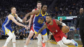 SAN FRANCISCO, CALIFORNIA - DECEMBER 30: Damian Lillard #0 of the Portland Trail Blazers dribbling the ball while closely defended by Jonathan Kuminga #00 of the Golden State Warriors during the second quarter of an NBA basketball game at Chase Center on December 30, 2022 in San Francisco, California. NOTE TO USER: User expressly acknowledges and agrees that, by downloading and or using this photograph, User is consenting to the terms and conditions of the Getty Images License Agreement. (Photo by Thearon W. Henderson/Getty Images)