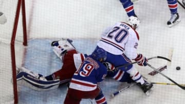 May 29, 2014; New York, NY, USA; New York Rangers goalie Henrik Lundqvist (30) pokes the puck away from Montreal Canadiens left wing Thomas Vanek (20) during the second period in game six of the Eastern Conference Final of the 2014 Stanley Cup Playoffs at Madison Square Garden. Mandatory Credit: Adam Hunger-USA TODAY Sports