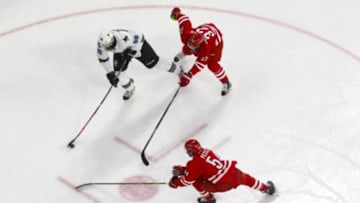 Feb 19, 2016; Raleigh, NC, USA; San Jose Sharks defensemen Brent Burns (88) gets ready to take a shot next to Carolina Hurricanes forward Kris Versteeg (32) and defensemen Brett Pesce (54) at PNC Arena. The Carolina Hurricanes defeated the San Jose Sharks 5-2. Mandatory Credit: James Guillory-USA TODAY Sports