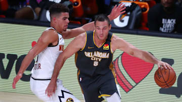 Aug 3, 2020; Lake Buena Vista, Florida, USA; Oklahoma City Thunder forward Danilo Gallinari (8) handles the ball against Denver Nuggets forward Michael Porter Jr. (1) during the second quarter in a NBA basketball game at The Arena. Mandatory Credit: Kim Klement-USA TODAY Sports