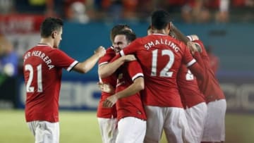 Aug 4, 2014; Miami Gardens, FL, USA; Manchester United midfielder Juan Mata (center) celebrates his goal with defender Chris Smalling (12) and Ander Herrera (21) in the second half of a game against Liverpool at Sun Life Stadium. Mandatory Credit: Robert Mayer-USA TODAY Sports