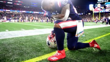 James White #28 of the New England Patriots kneels on the sideline prior to the game against the New York Giants at Gillette Stadium on October 10, 2019 in Foxborough, Massachusetts. (Photo by Billie Weiss/Getty Images)