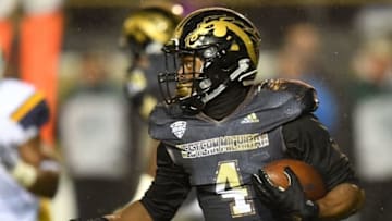 Nov 25, 2016; Kalamazoo, MI, USA; Western Michigan Broncos cornerback Darius Phillips (4) runs the ball against the Toledo Rockets during the first half at Waldo Stadium. Mandatory Credit: Patrick Gorski-USA TODAY Sports