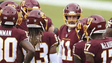 LANDOVER, MARYLAND - OCTOBER 11: Alex Smith #11 of the Washington Football Team talks with his teammates in the second quarter against the Los Angeles Rams at FedExField on October 11, 2020 in Landover, Maryland. (Photo by Patrick McDermott/Getty Images)