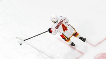 Jan 24, 2016; Raleigh, NC, USA; Calgary Flames defensemen Kris Russell (4) skates with the puck against the Carolina Hurricanes at PNC Arena. The Carolina Hurricanes defeated the Calgary Flames 5-2. Mandatory Credit: James Guillory-USA TODAY Sports