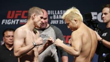 Jul 24, 2015; Chicago, IL, USA; Joe Lauzon left and Takanori Gomi right during weigh ins for UFC Fight Night at United Center. Mandatory Credit: Kamil Krzaczynski-USA TODAY Sports